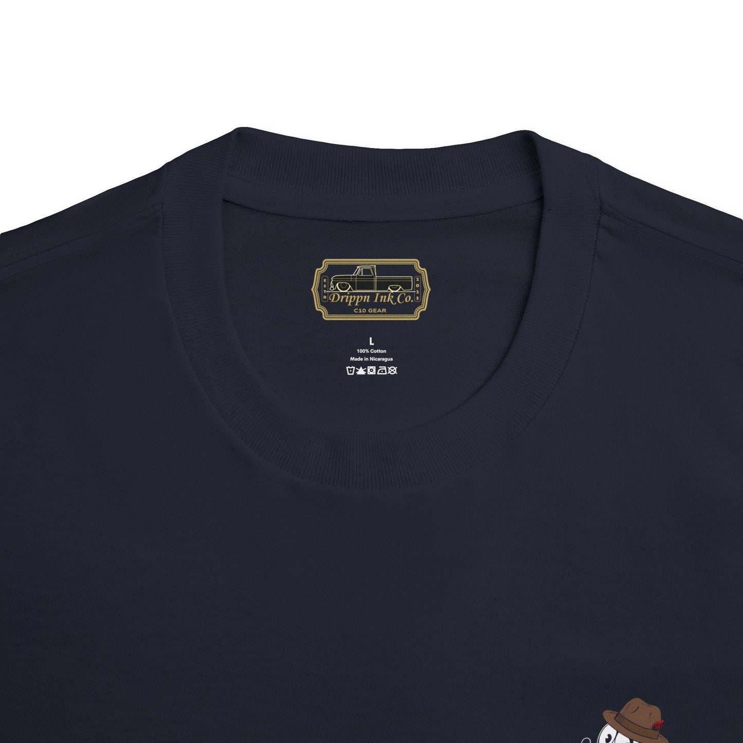 Black t-shirt featuring a large graphic of Felix In a Fedora, the text “The Heartbeat of America,” and a slammed Chevy C10 truck on the back, with matching front badge.