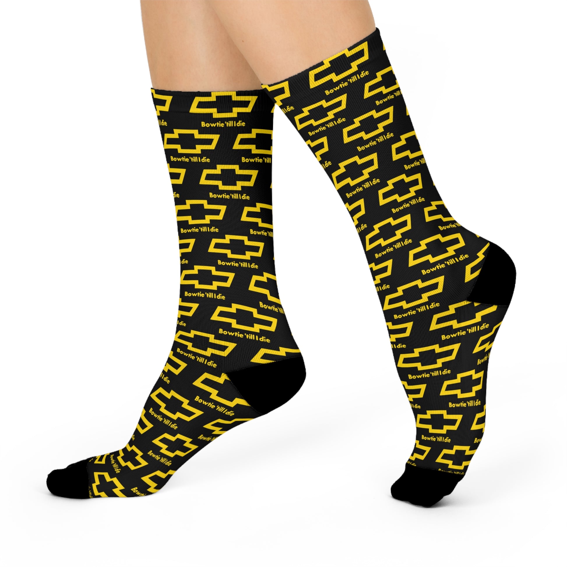 Black crew socks with yellow Chevy bowtie logos and "Bowtie 'Till I Die" text in an all-over print pattern, shown on legs.