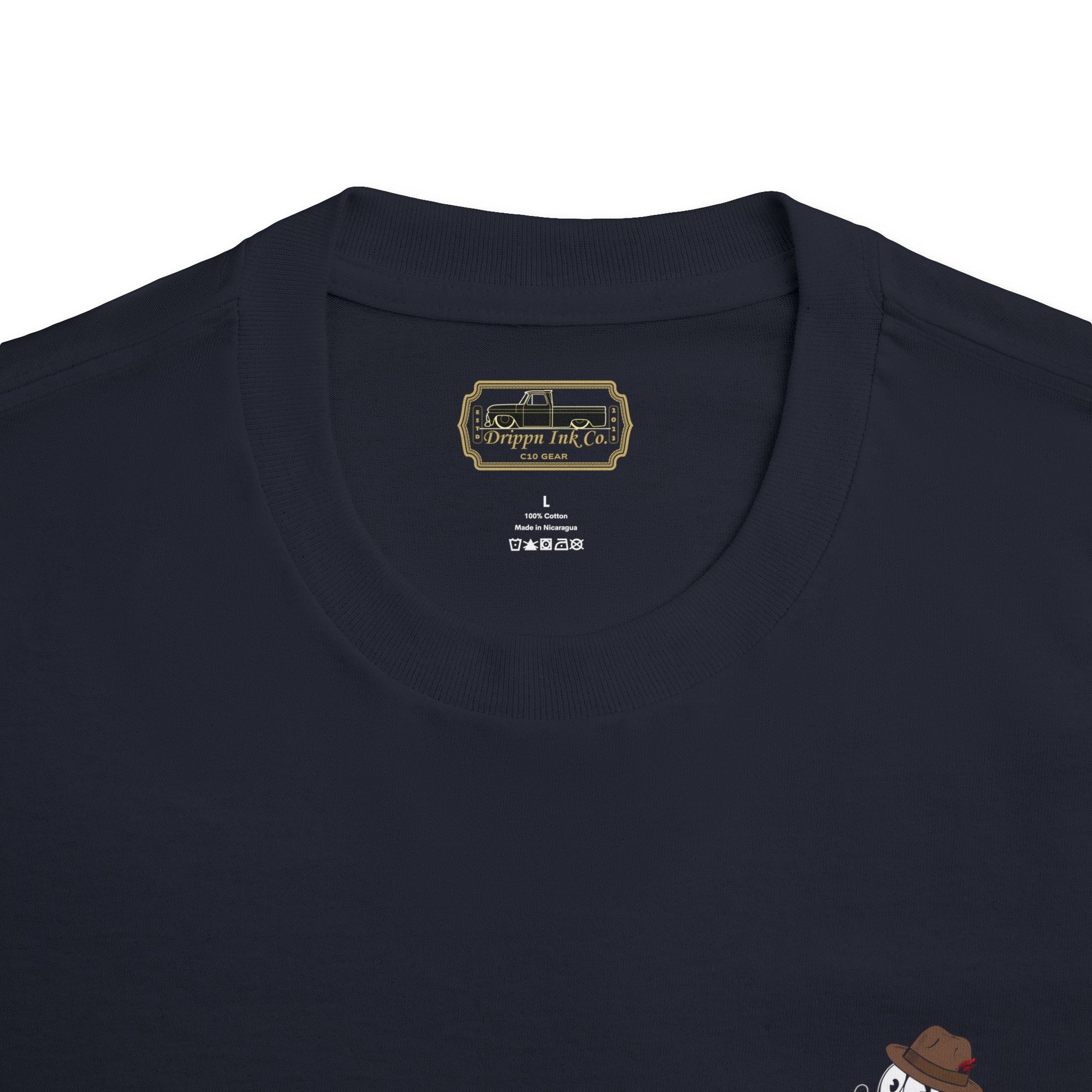 Black t-shirt featuring a large graphic of Felix In a Fedora, the text “The Heartbeat of America,” and a slammed Chevy C10 truck on the back, with matching front badge.