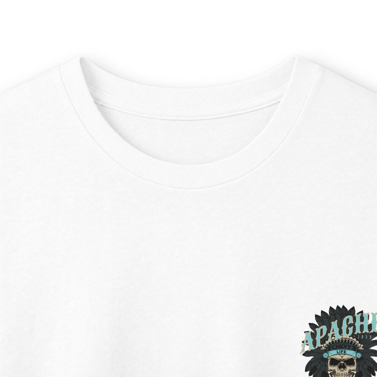 Close crop of the white long sleeve showing part of the Apache skull print against the fabric.
