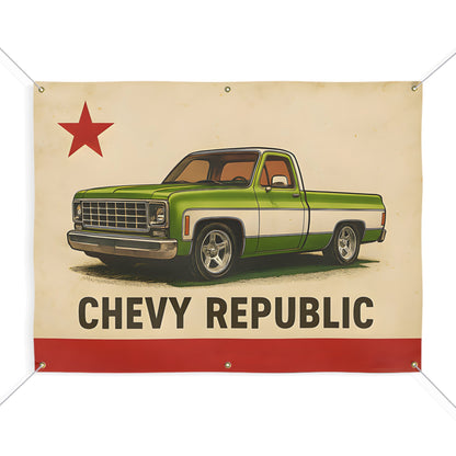 Cream fabric banner with corner grommets, a red star in the top left, a green and white squarebody pickup truck in the centre, and Chevy Republic in block letters over a red bar.