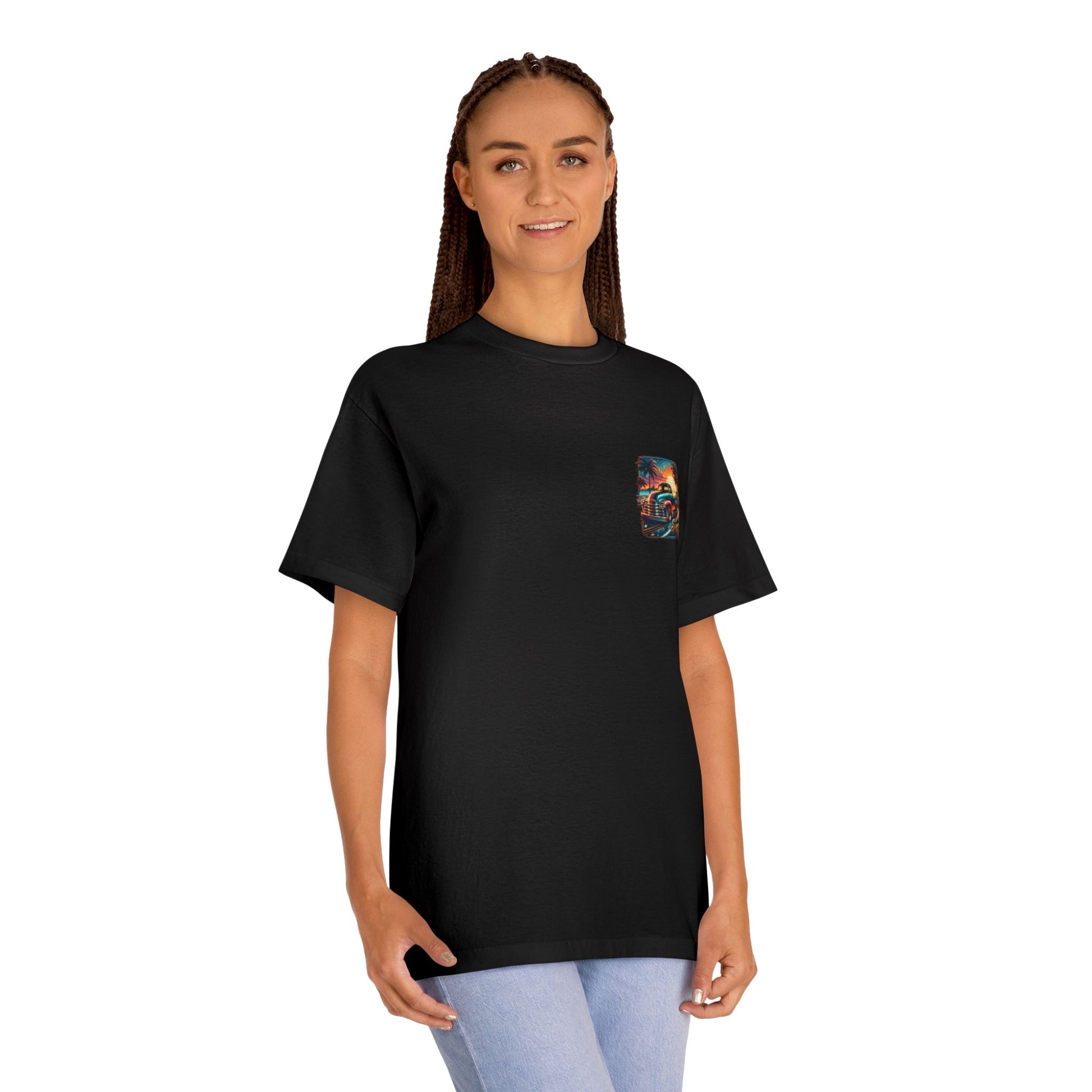 A woman wearing the black t-shirt, showing the small chest print of the beach sunset scene.