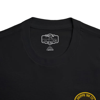 Close view of the shirt's inside neck label, a printed Drippn Ink C10 Gear badge, with the edge of the gold Low Life badge visible below.
