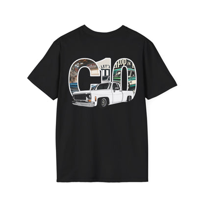 Back of the black t-shirt with a large print: the letters C10 filled with a photographic garage scene and a white lowered squarebody pickup in front of them.