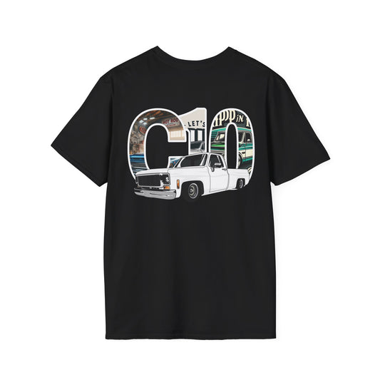 Back of the black t-shirt with a large print: the letters C10 filled with a photographic garage scene and a white lowered squarebody pickup in front of them.