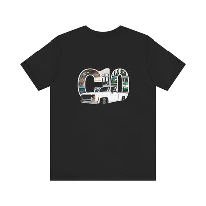 Big C10 Sqarebody This stylish t-shirt features a bold, eye-catching design that celebrates the classic Chevy C10 square body truck. Dominating the scene is the iconic outline of the C10, filled with detailed illustrations that pay homage to the vintage automotive culture.