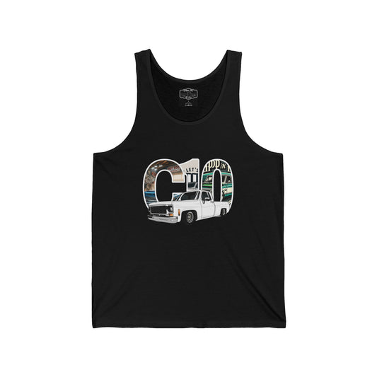 Black tank top, front view, printed with the letters C10 filled with a garage scene and a white lowered squarebody pickup in front of them.