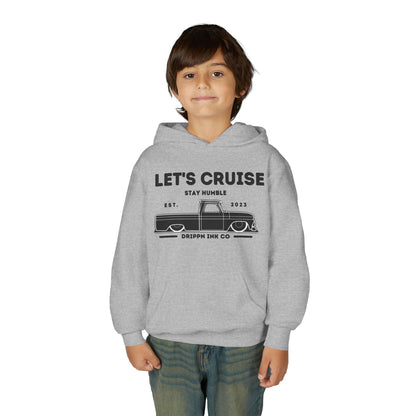 A boy wearing the grey hoodie, front view, showing the Let's Cruise print and the lowered pickup across his chest.